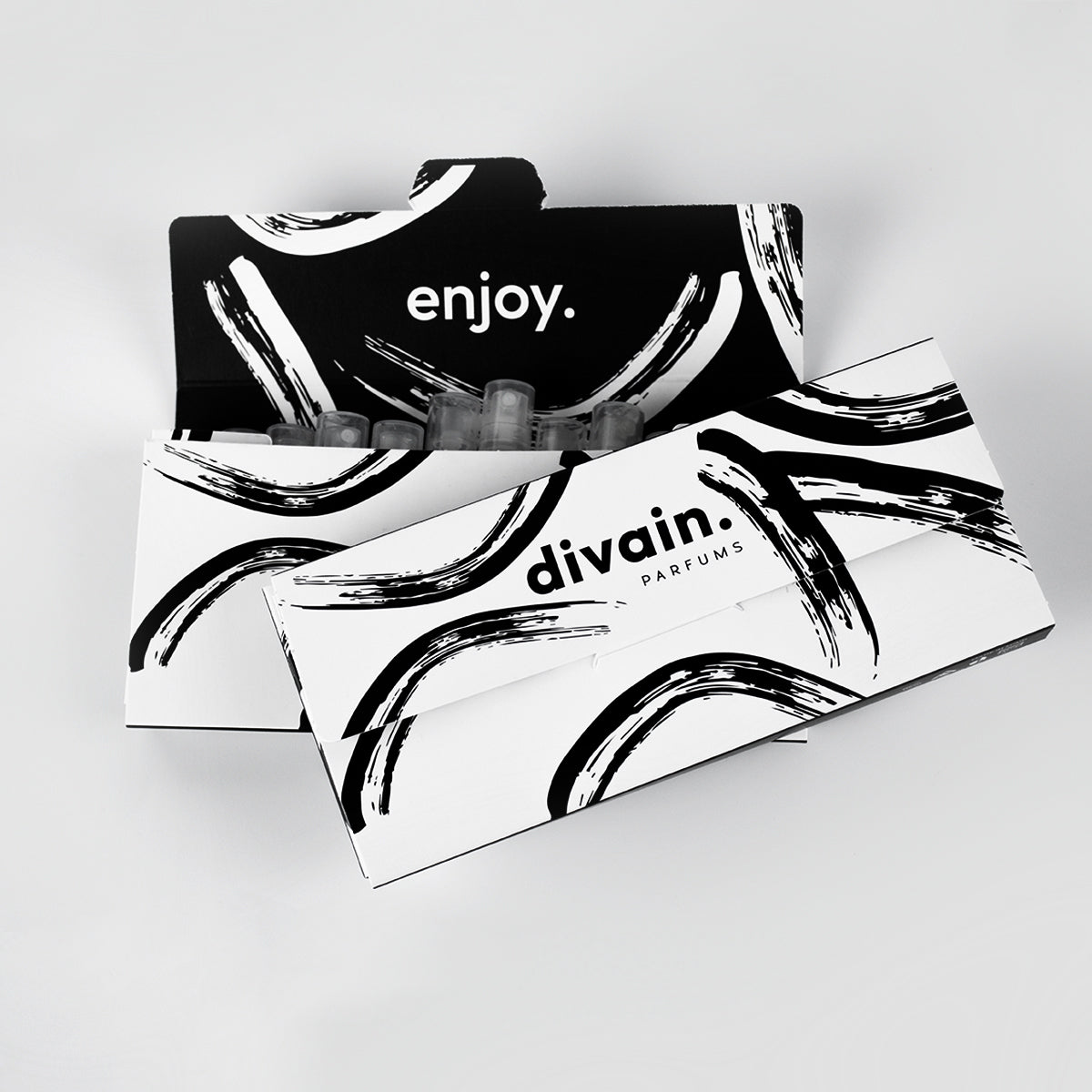 White box with black divain stripes with a text saying enjoy